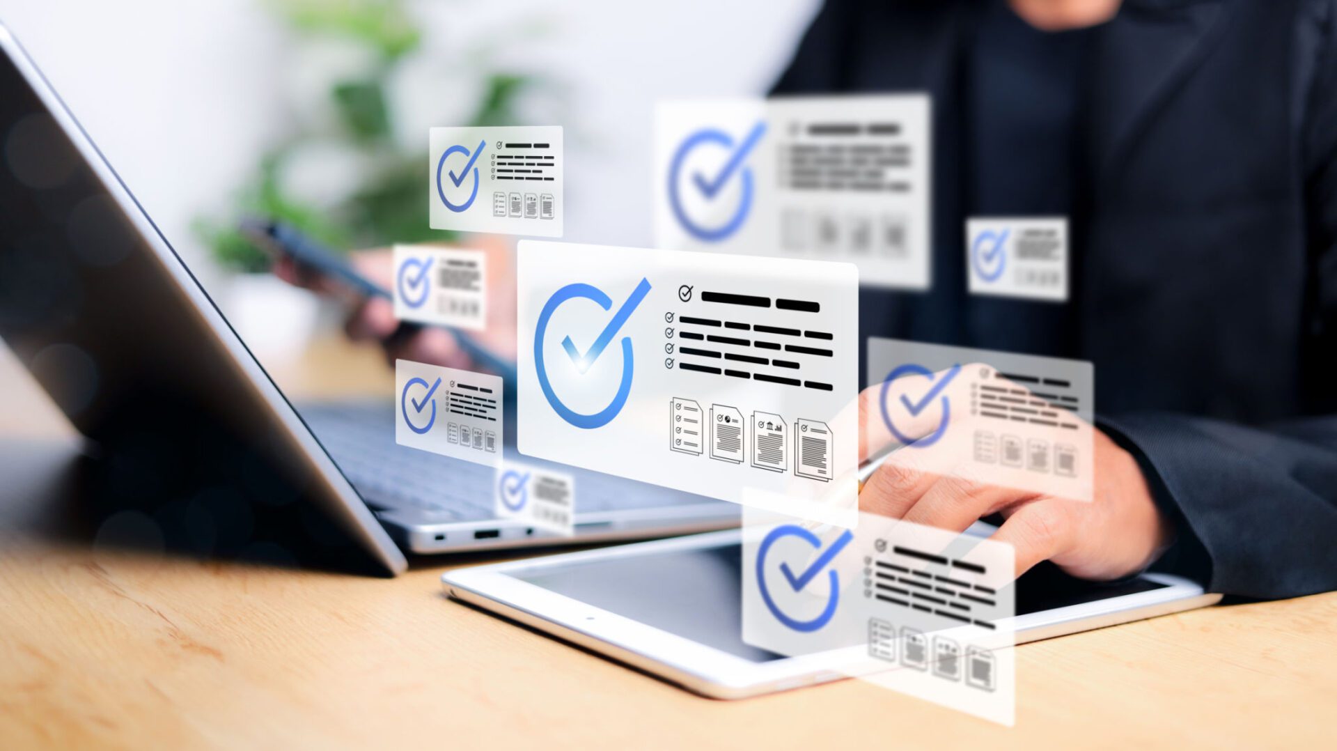 Digital checkmarks hovering over laptop and tablet.