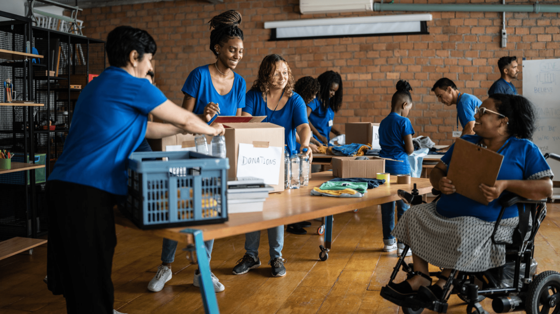 Volunteers organizing supplies in community center.