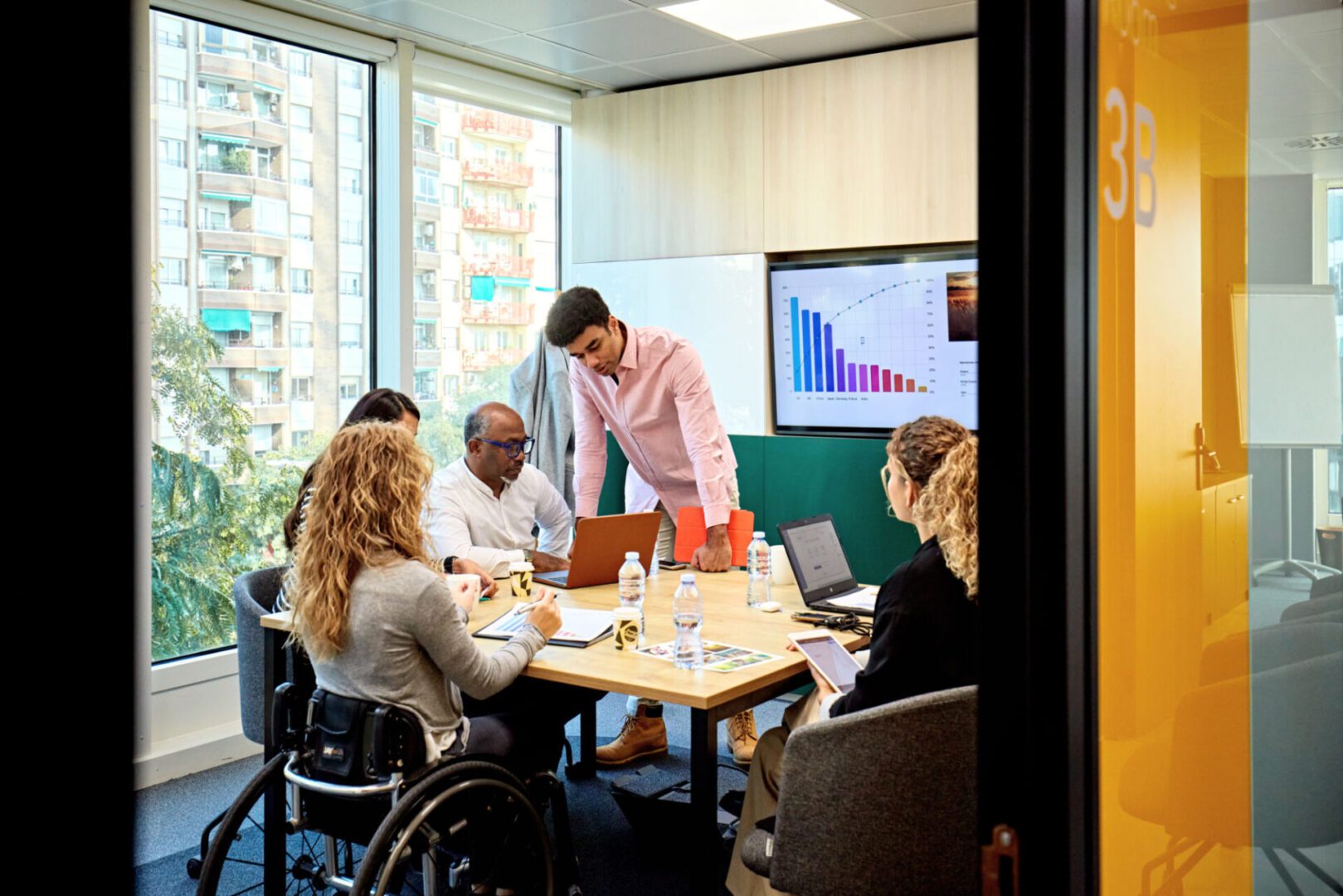 Office meeting with presentation and diverse team.